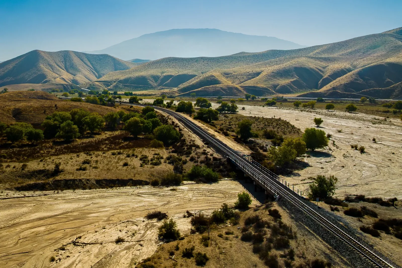 Aerial Perspectives — Railroad crossing a dry riverbed